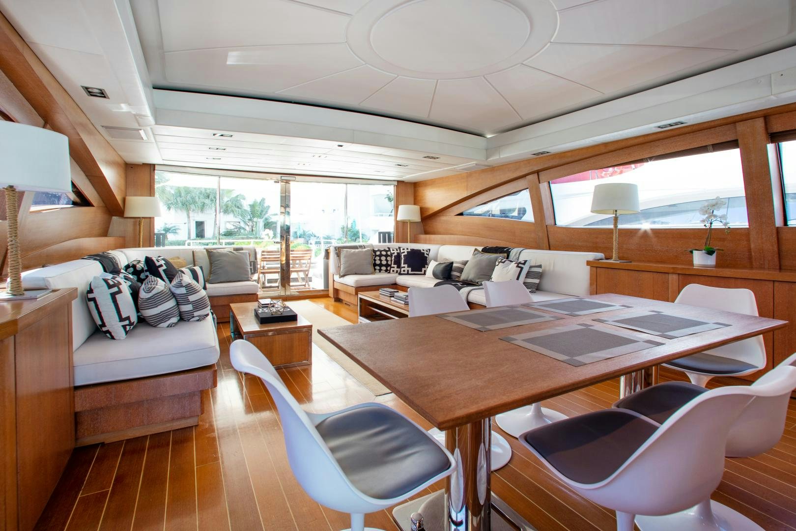 a living room with a large table and chairs aboard SMILE Yacht for Sale