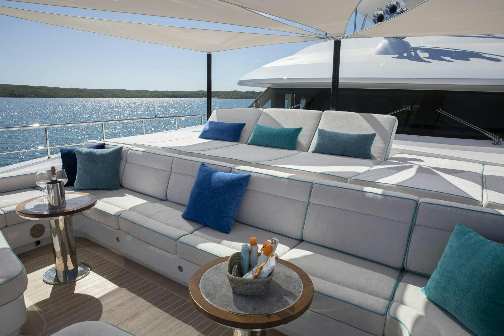 a couch with pillows and a table on it aboard JODI ANN Yacht for Sale
