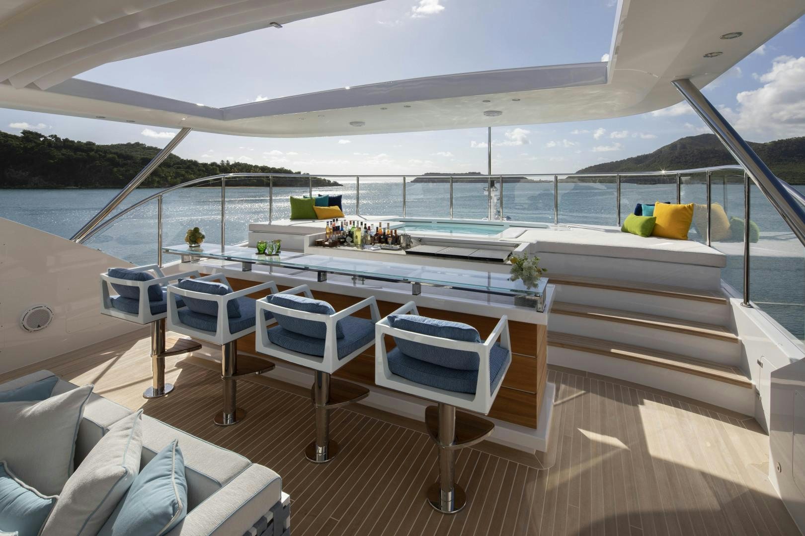 a deck with a pool and a deck with chairs and tables aboard JODI ANN Yacht for Sale