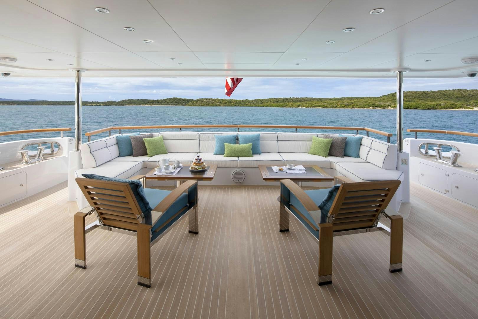 a deck with a table and chairs aboard JODI ANN Yacht for Sale