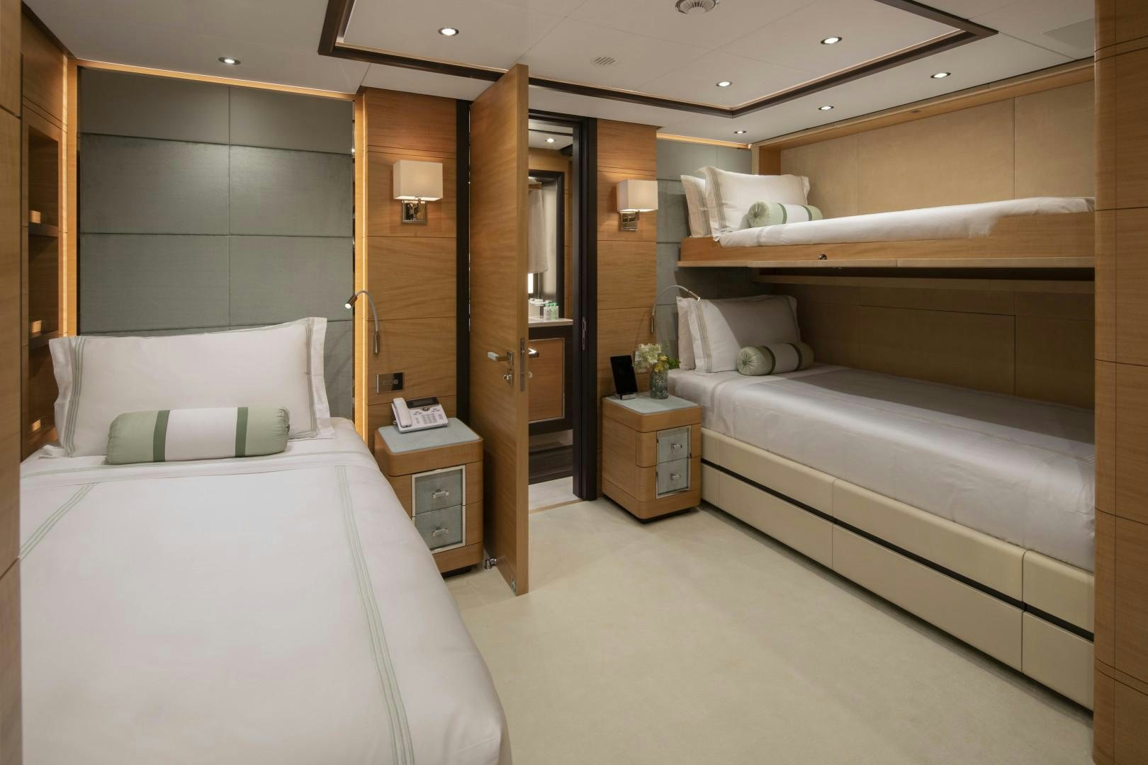 a room with a bed and a dresser aboard JODI ANN Yacht for Sale