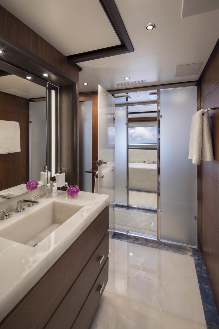 a bathroom with a shower unit and sink aboard JODI ANN Yacht for Sale