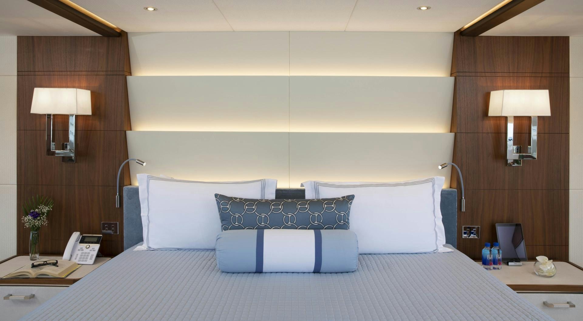 a bed with a blue and white bed spread aboard JODI ANN Yacht for Sale