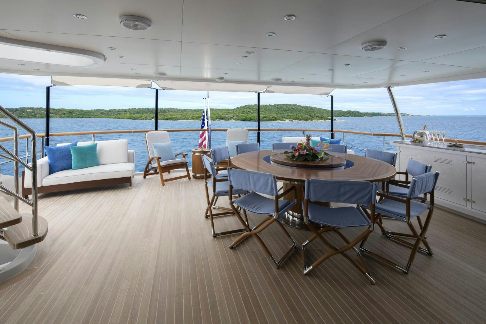 a large room with a table and chairs and a large window aboard JODI ANN Yacht for Sale