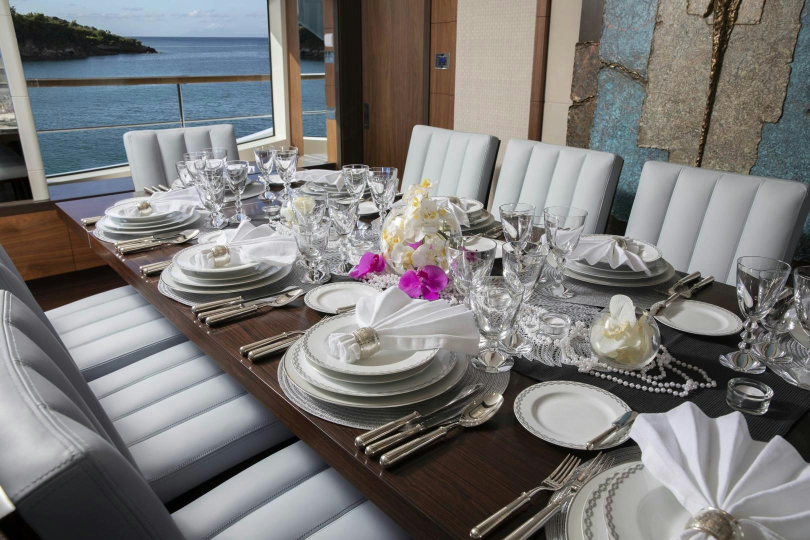 a table set with plates and silverware aboard JODI ANN Yacht for Sale