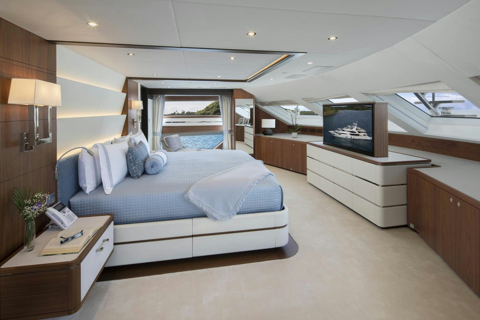 a bedroom with a bed and a tv aboard JODI ANN Yacht for Sale