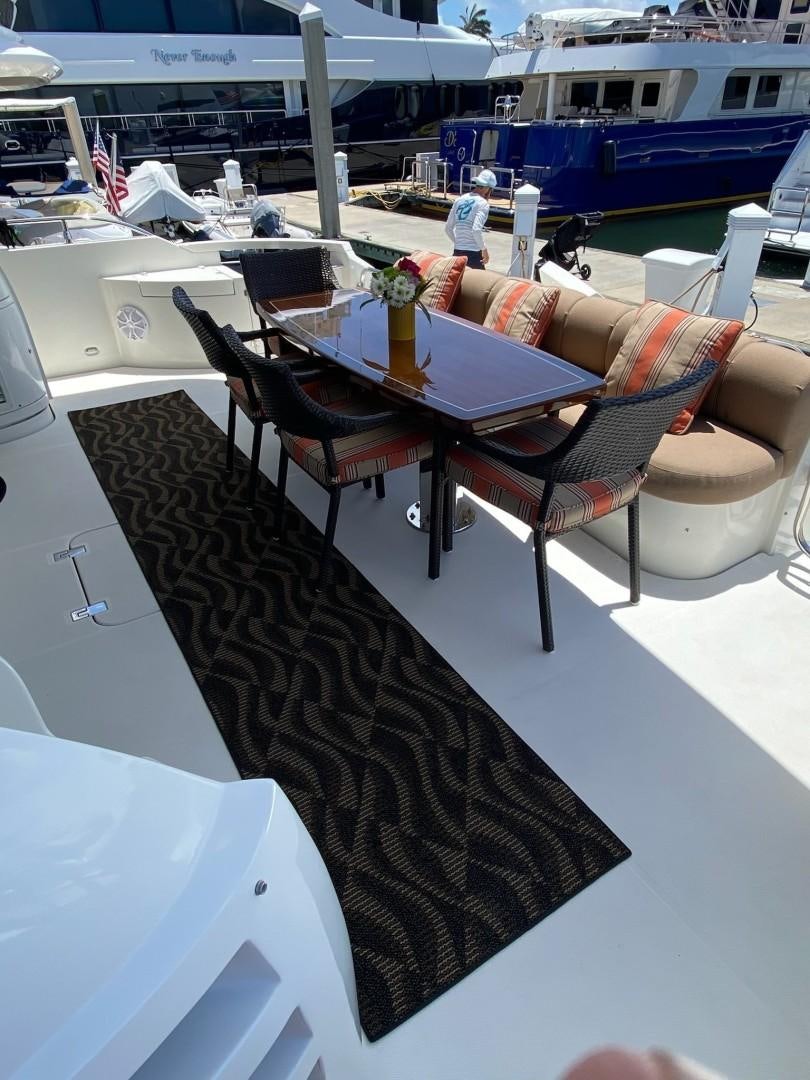 a table with chairs on it aboard Gettin' There Yacht for Sale