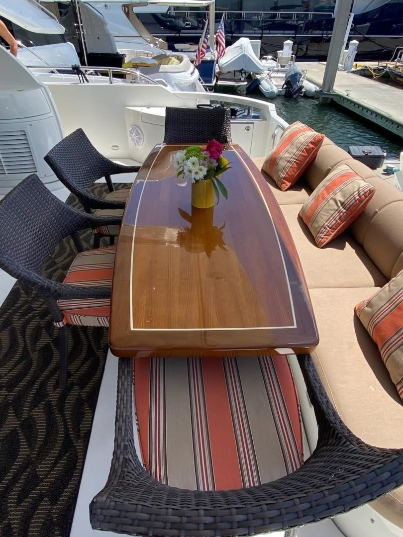 a table with a vase of flowers on it aboard Gettin' There Yacht for Sale