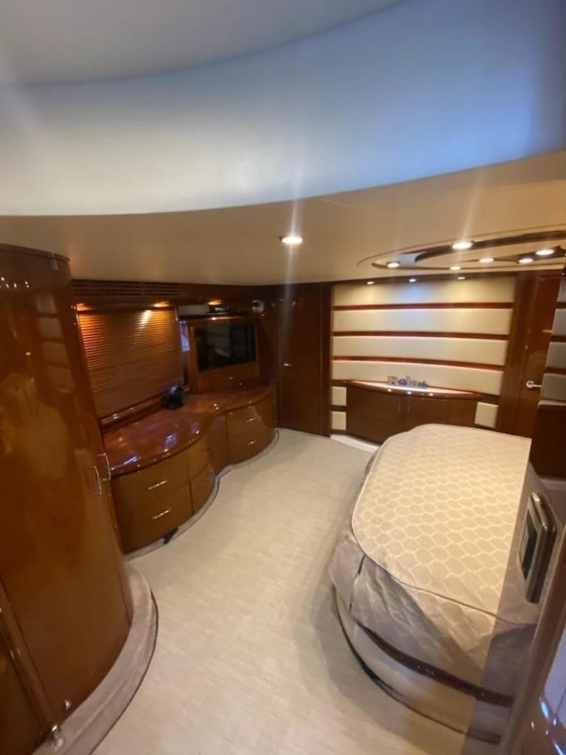 a bedroom with a bed and a television aboard Gettin' There Yacht for Sale