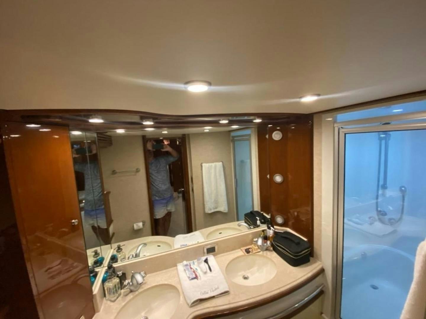 a person taking a picture of themselves in a bathroom mirror aboard Gettin' There Yacht for Sale