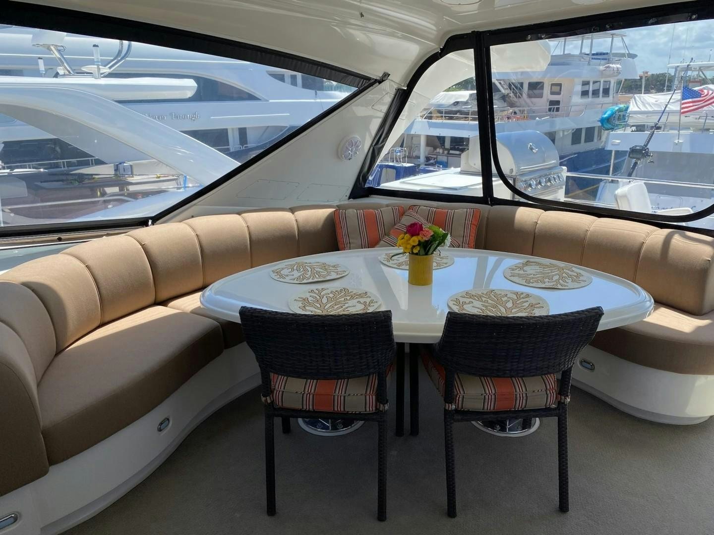 a table with plates and chairs on it next to a window aboard Gettin' There Yacht for Sale