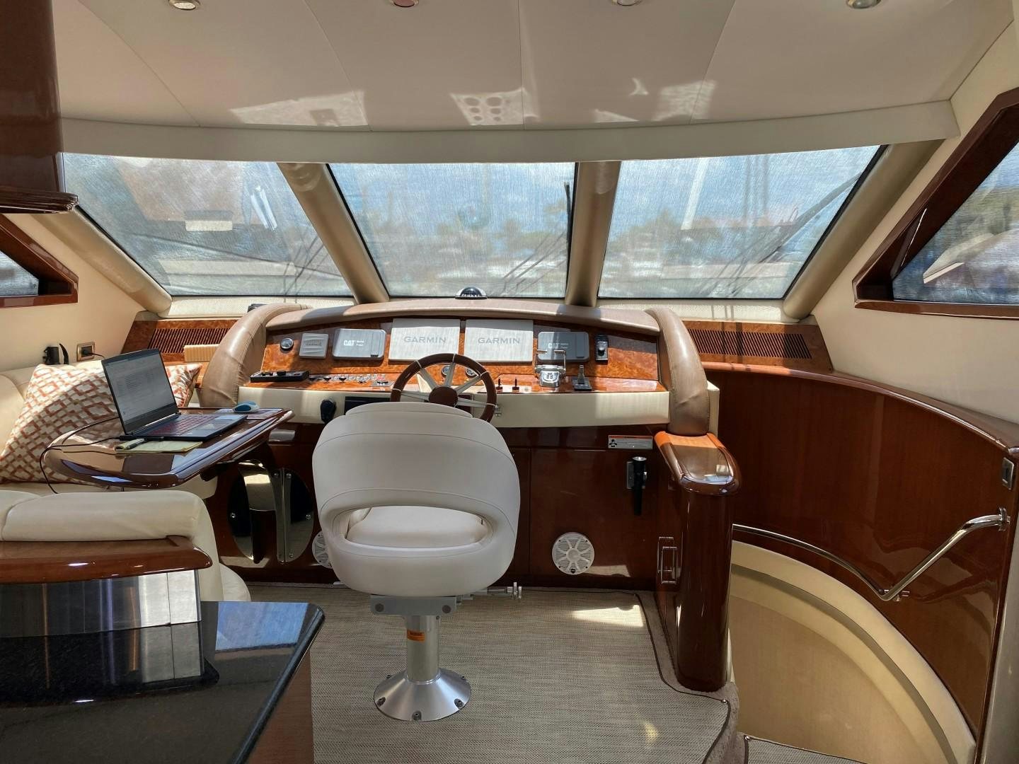 inside of a vehicle with a desk and a laptop on a table aboard Gettin' There Yacht for Sale