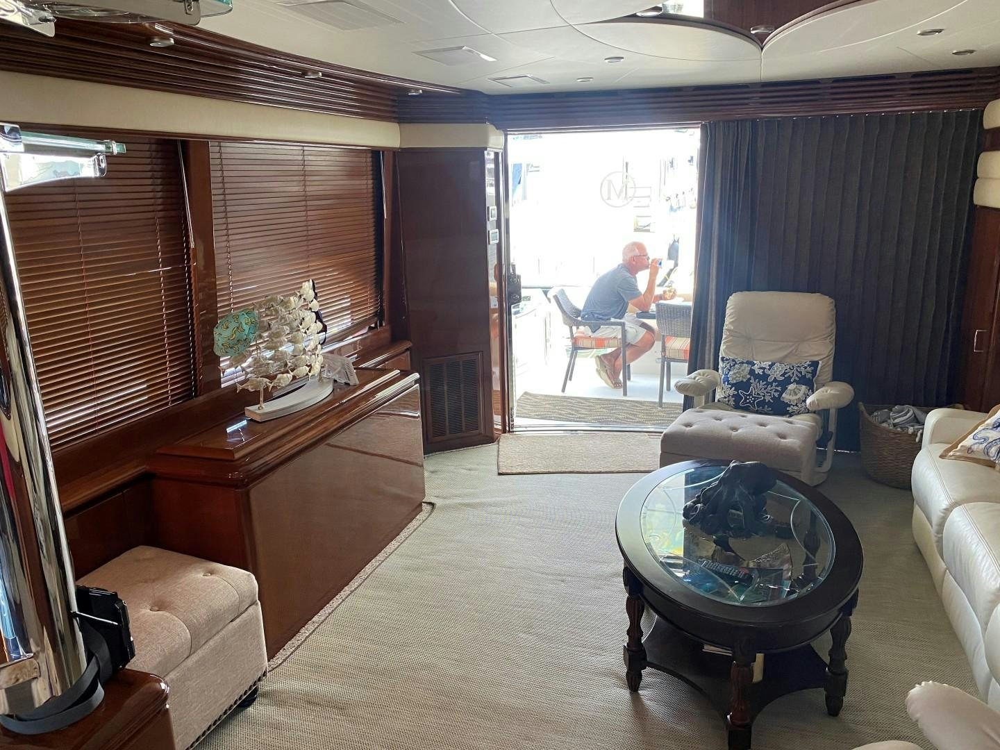 a person sitting on a chair in a living room aboard Gettin' There Yacht for Sale