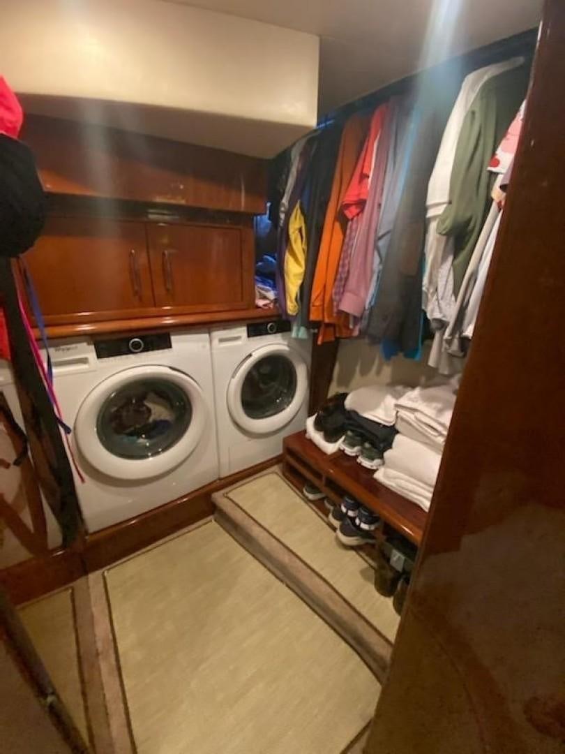 a laundry room with clothes on the wall aboard Gettin' There Yacht for Sale