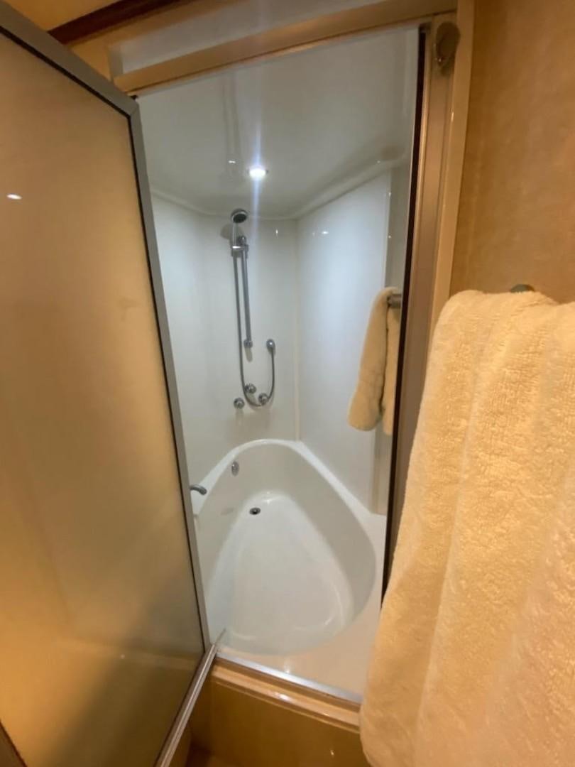 a bathroom with a bathtub and shower aboard Gettin' There Yacht for Sale