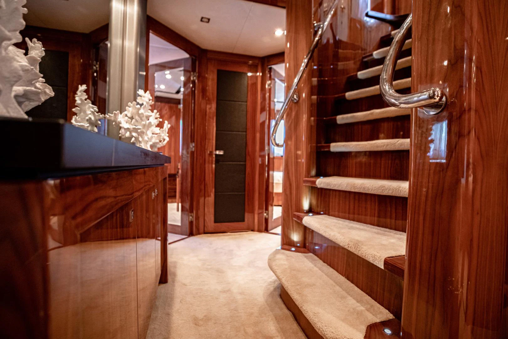 a room with wooden stairs and a wood door aboard LE SORELLE III Yacht for Sale