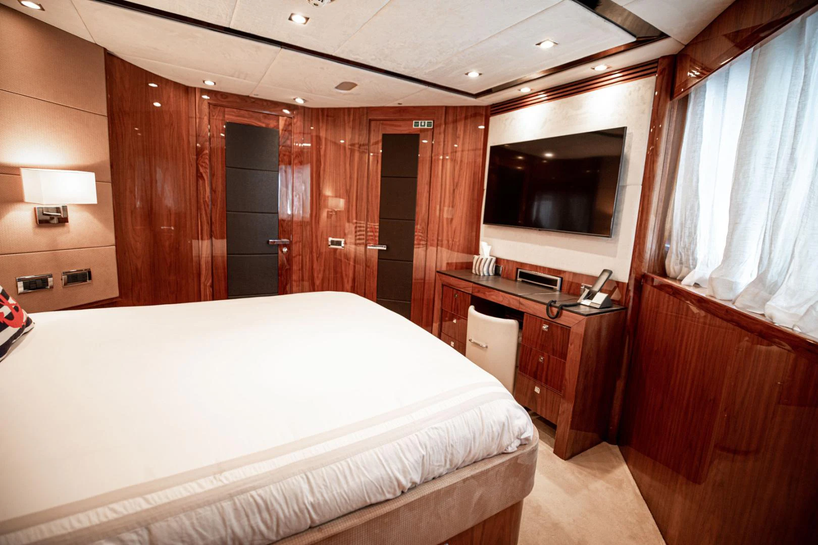 a room with a bed and a television aboard LE SORELLE III Yacht for Sale