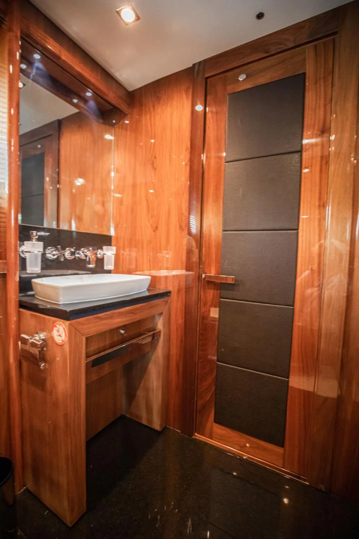 a wooden bathroom with wooden cabinets aboard LE SORELLE III Yacht for Sale