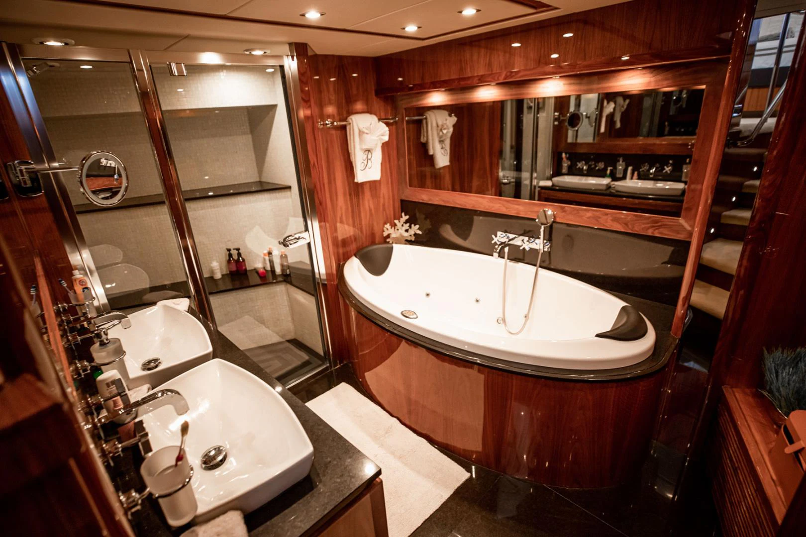 a bathroom with a bathtub and sink aboard LE SORELLE III Yacht for Sale