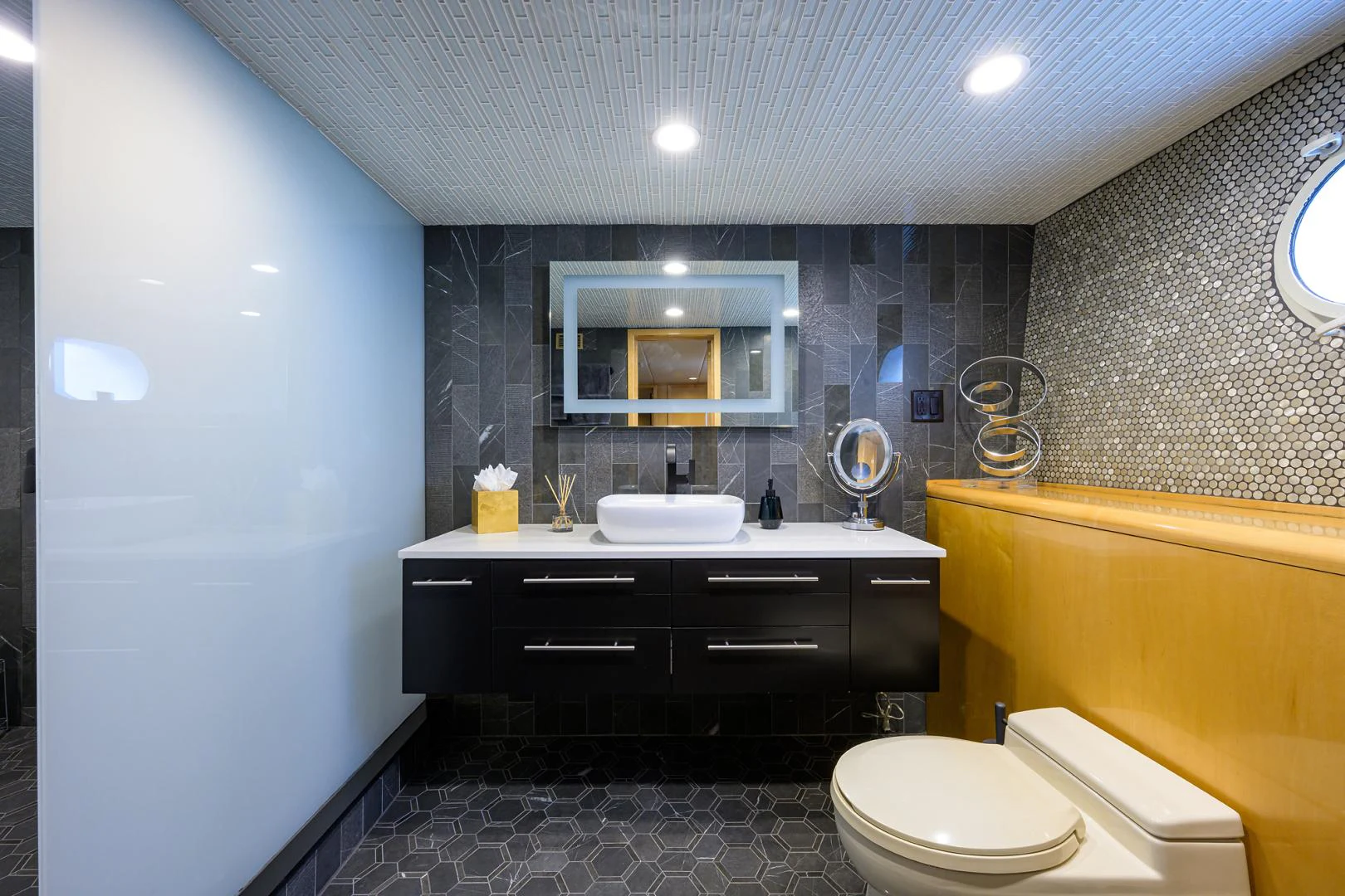 a bathroom with a sink toilet and a mirror aboard MEMORYMAKER Yacht for Sale