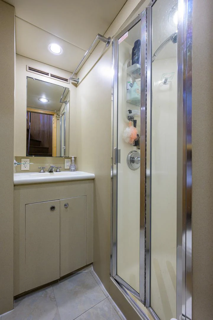 a bathroom with a shower unit and sink aboard MEMORYMAKER Yacht for Sale