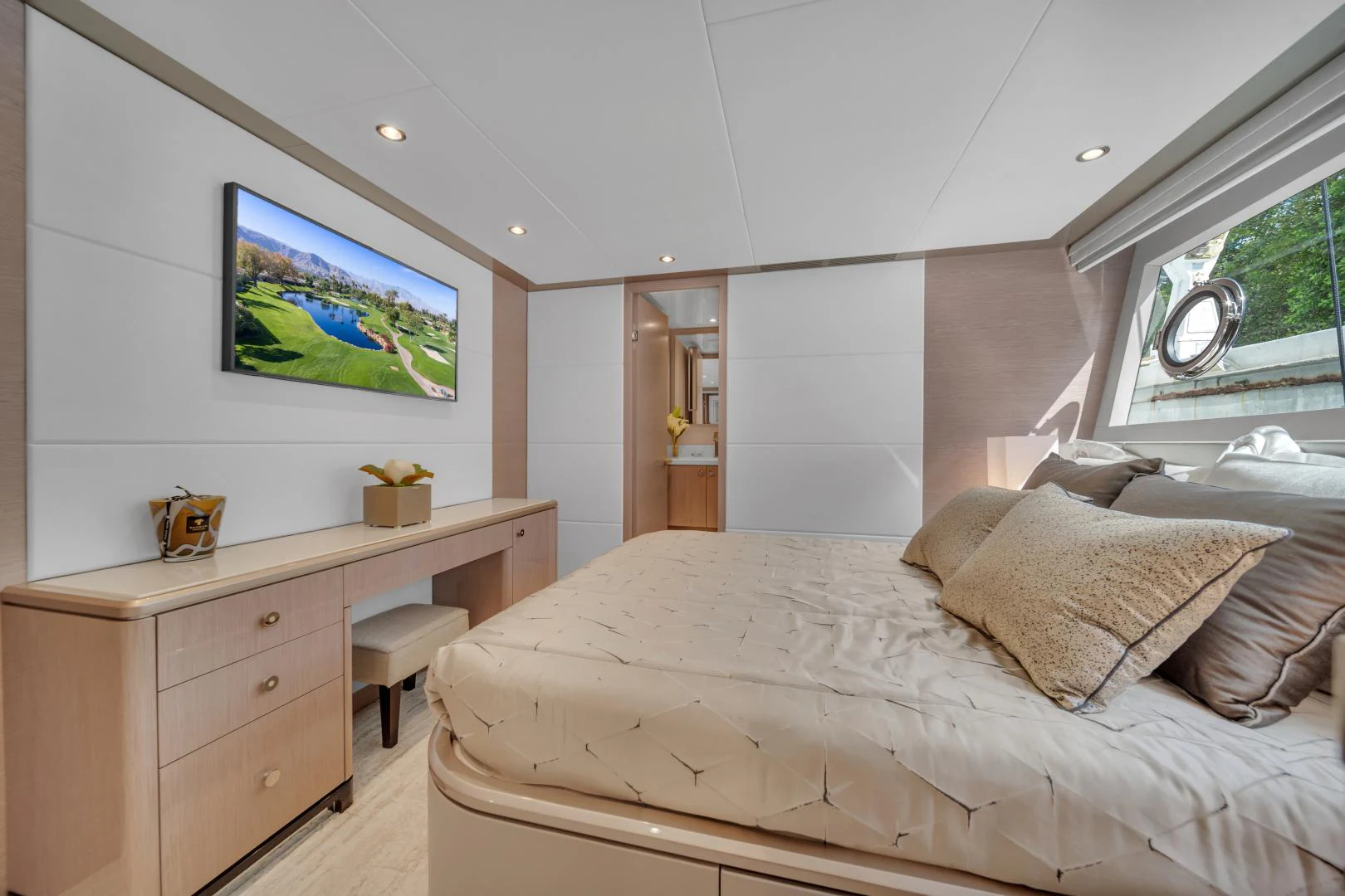 a bedroom with a bed and a desk aboard CARBON COPY Yacht for Sale