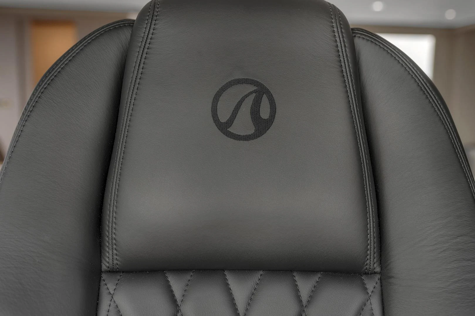 a black leather chair aboard CARBON COPY Yacht for Sale