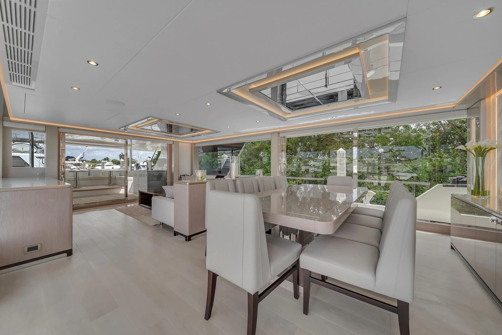 a room with a large window and a table and chairs aboard CARBON COPY Yacht for Sale