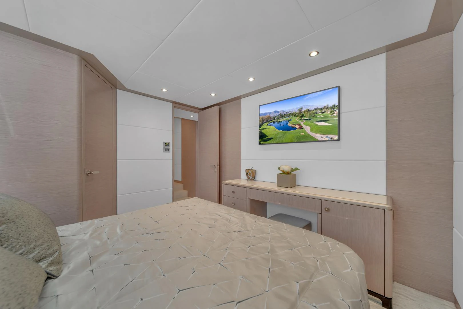 a bedroom with a tv on the wall aboard CARBON COPY Yacht for Sale