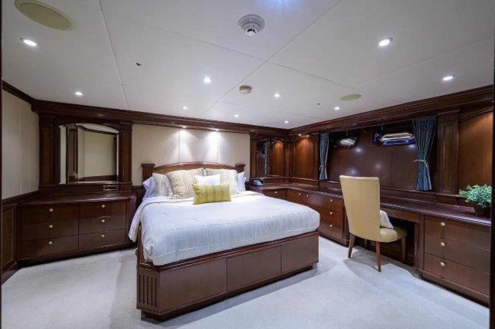 a bedroom with a bed and a chair aboard REBECCA Yacht for Sale