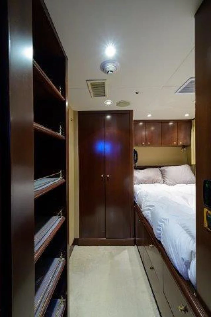 a bedroom with a bed and a door aboard REBECCA Yacht for Sale