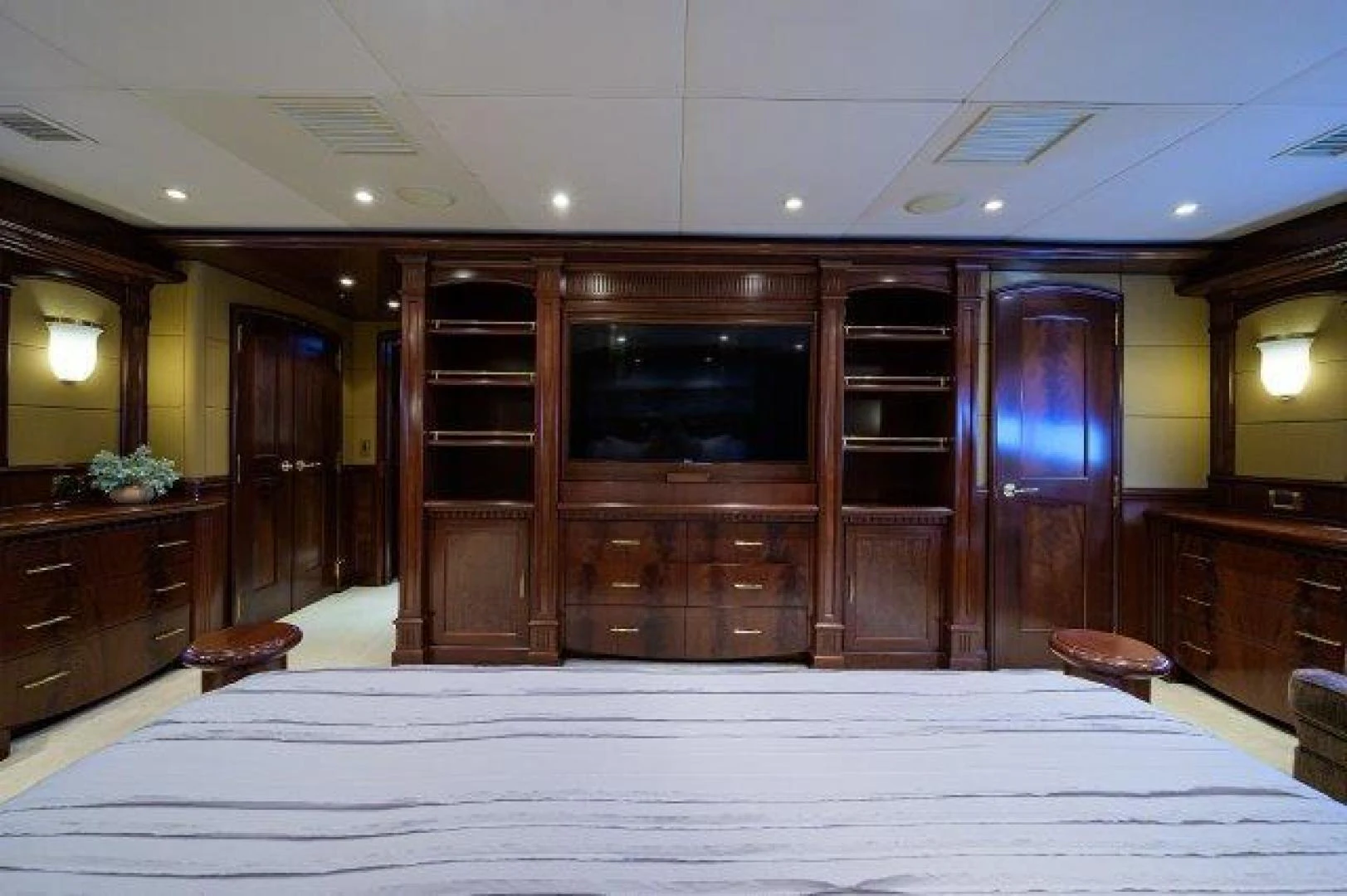a large room with a large white bed and a large wooden cabinet aboard REBECCA Yacht for Sale