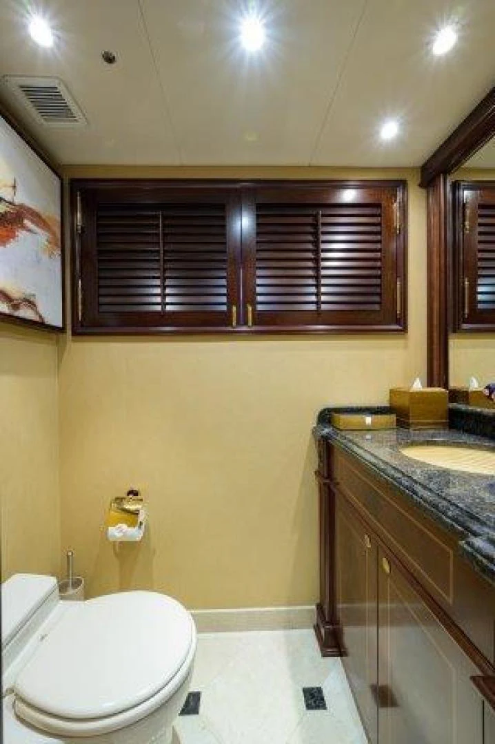 a bathroom with a toilet and a sink aboard REBECCA Yacht for Sale
