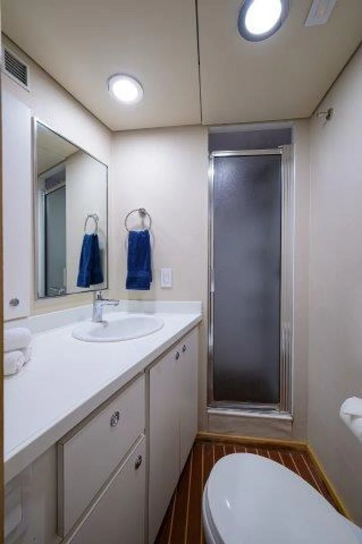 a bathroom with a shower unit and sink aboard REBECCA Yacht for Sale