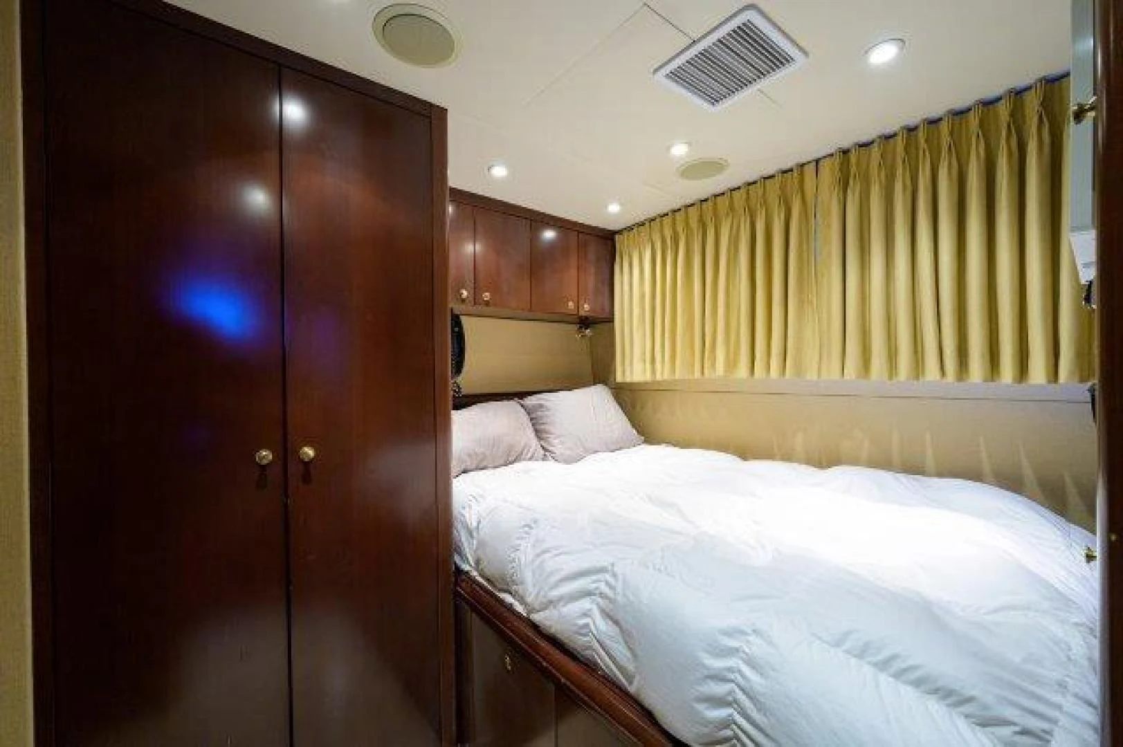a bedroom with a bed and a closet aboard REBECCA Yacht for Sale