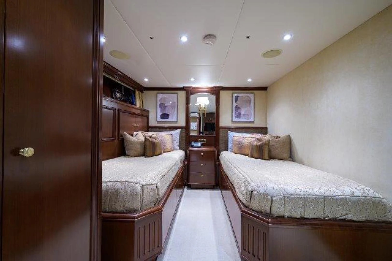 a bedroom with a bed and a mirror aboard REBECCA Yacht for Sale