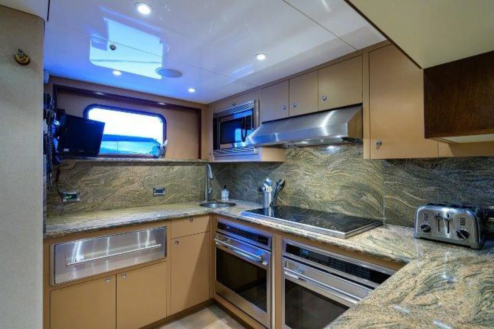 a kitchen with a large window aboard REBECCA Yacht for Sale