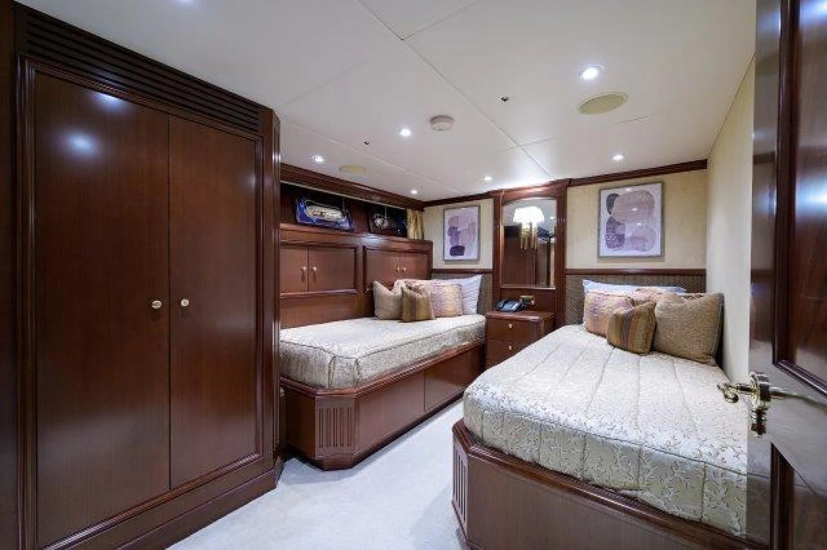 a bedroom with a bed and a closet aboard REBECCA Yacht for Sale