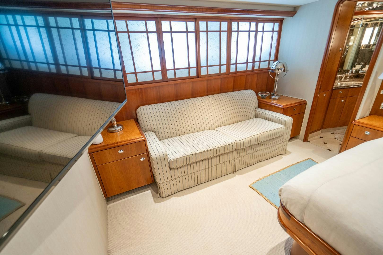 a room with a bed and a window aboard LEGACY Yacht for Sale