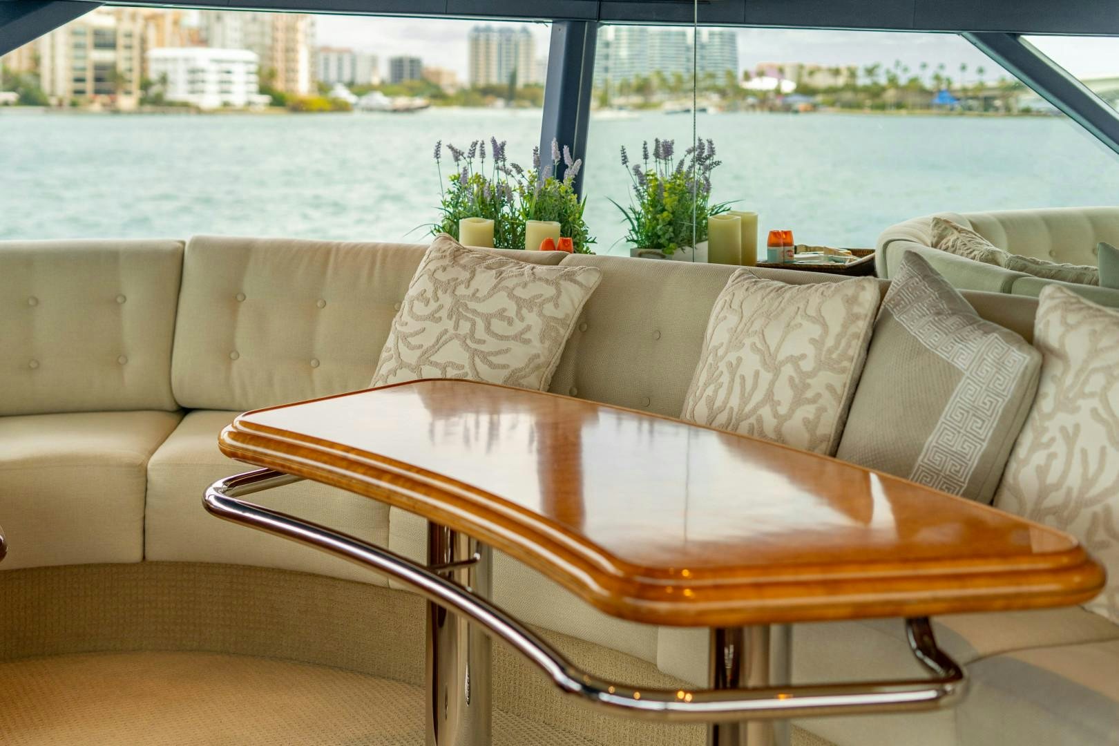a couch with pillows and a plant on it aboard LEGACY Yacht for Sale