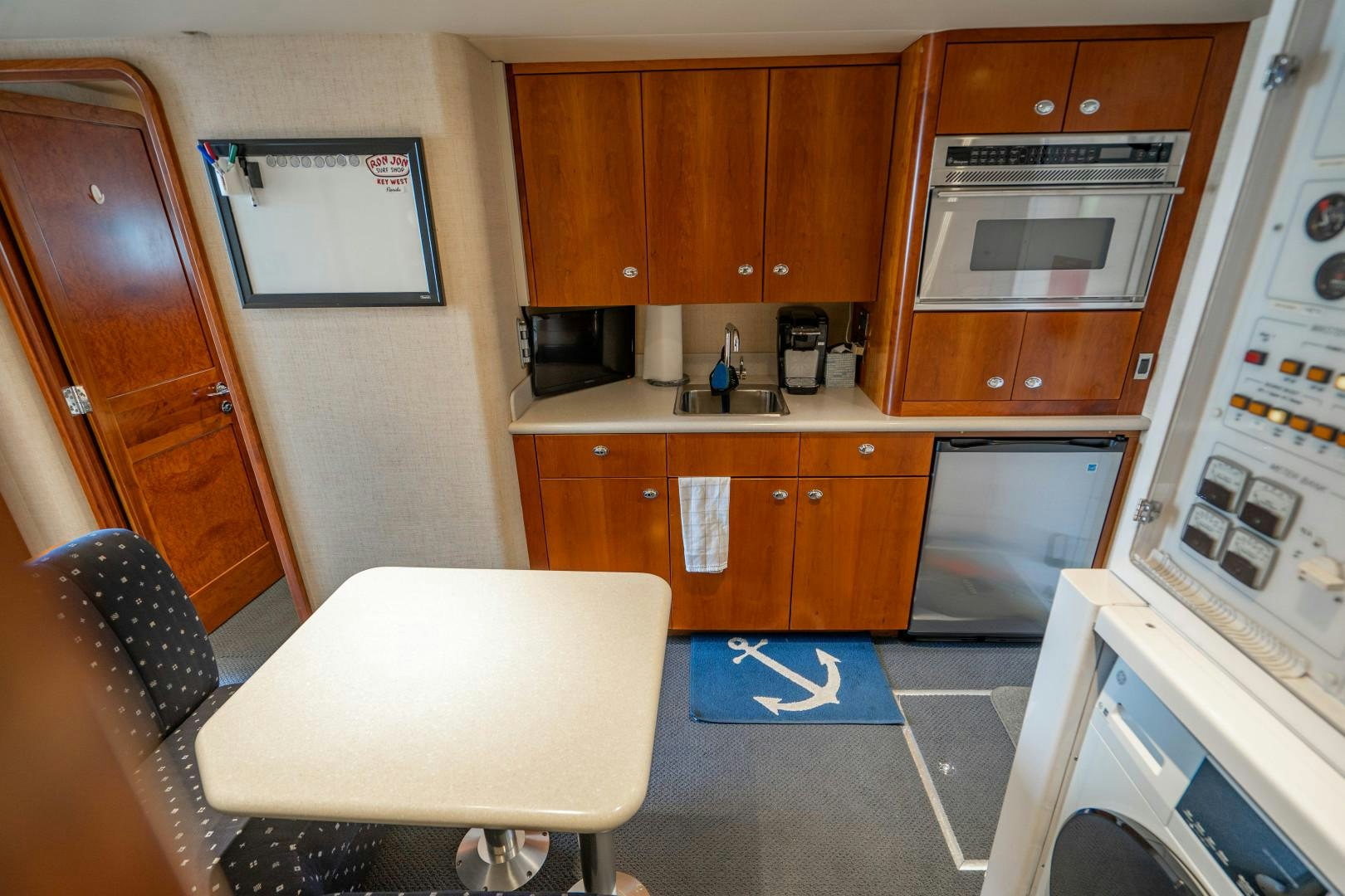 a kitchen with wooden cabinets aboard LEGACY Yacht for Sale