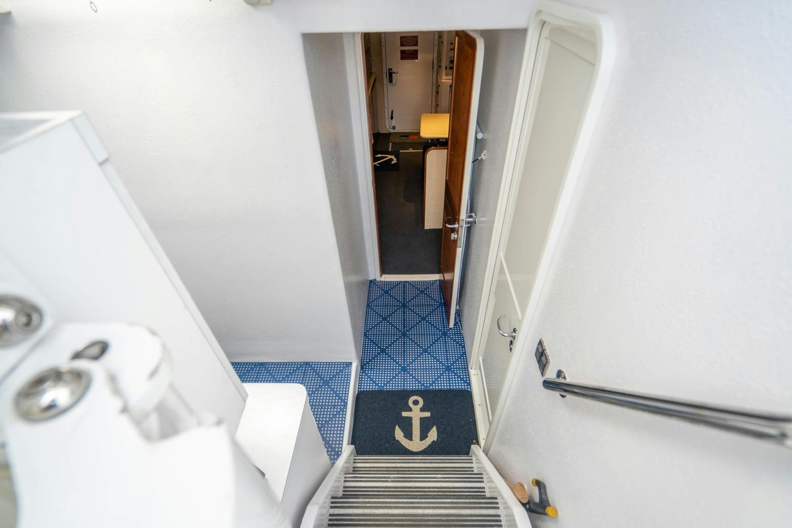 a hallway with a blue tile floor aboard LEGACY Yacht for Sale