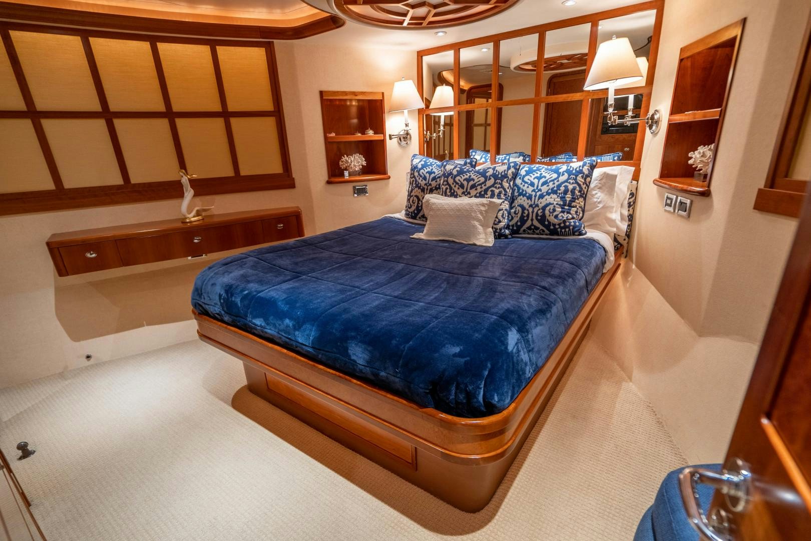a large blue bed in a hotel room aboard LEGACY Yacht for Sale