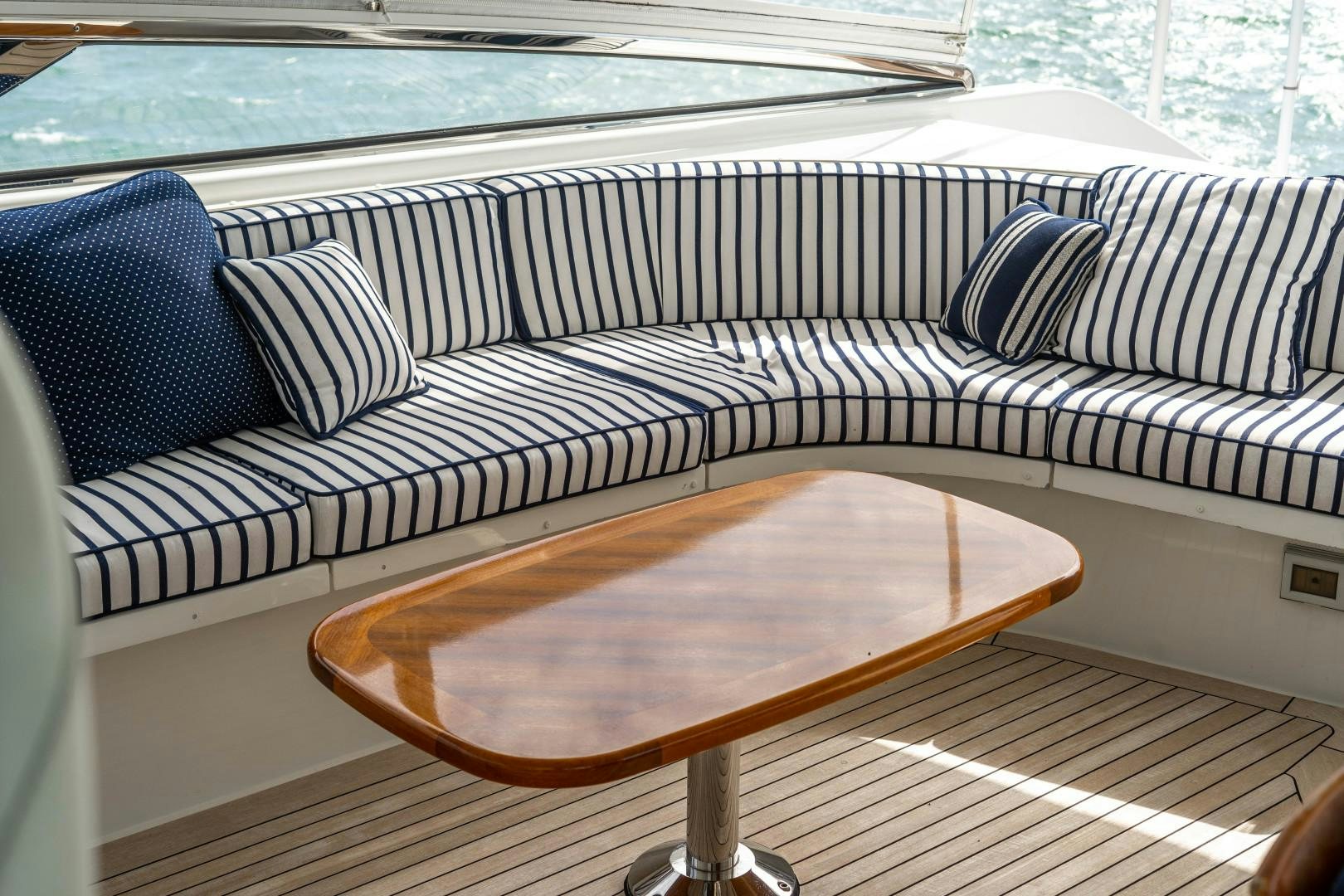 a couch with a table on it aboard LEGACY Yacht for Sale
