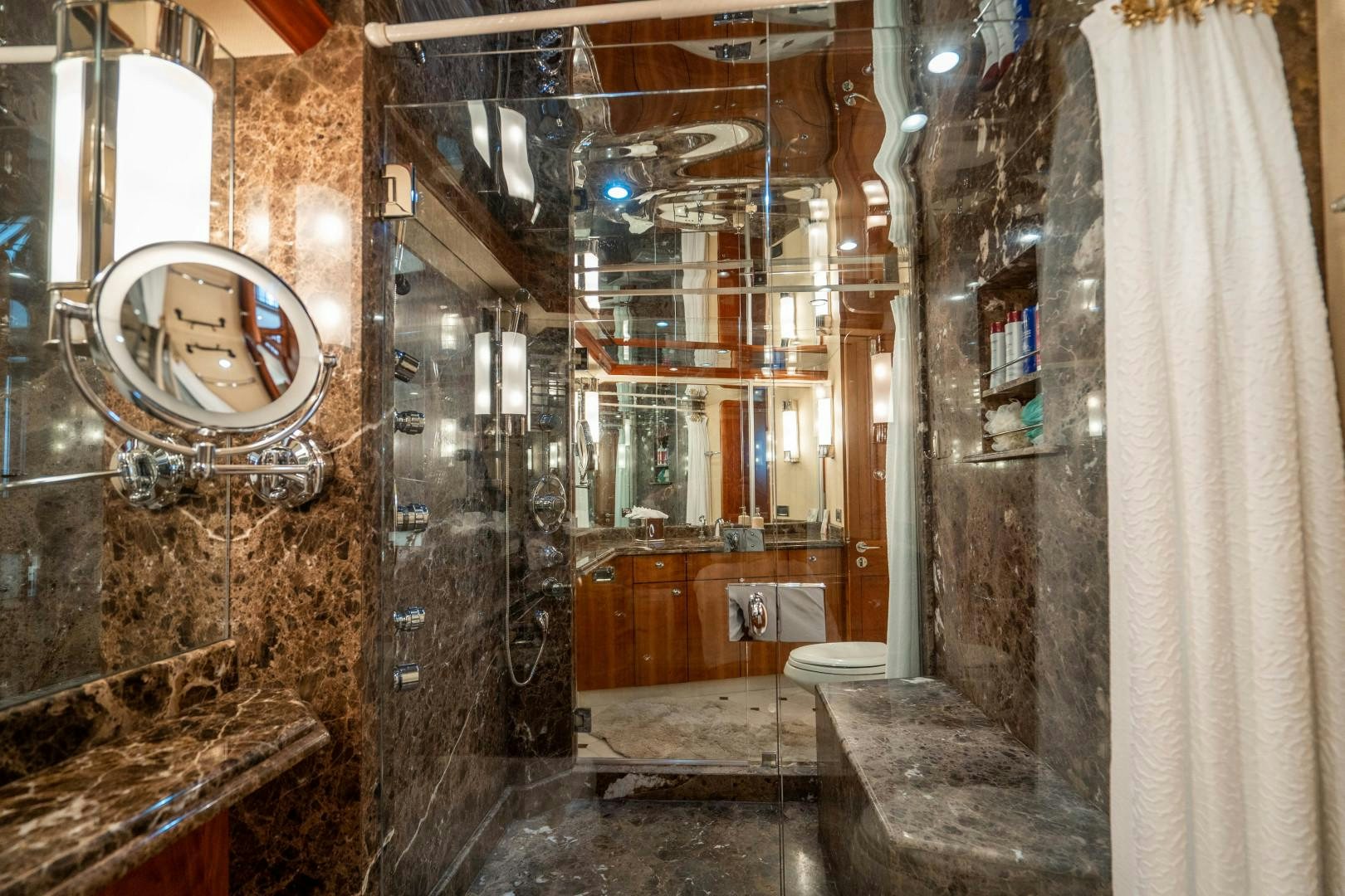 a bathroom with a large mirror aboard LEGACY Yacht for Sale