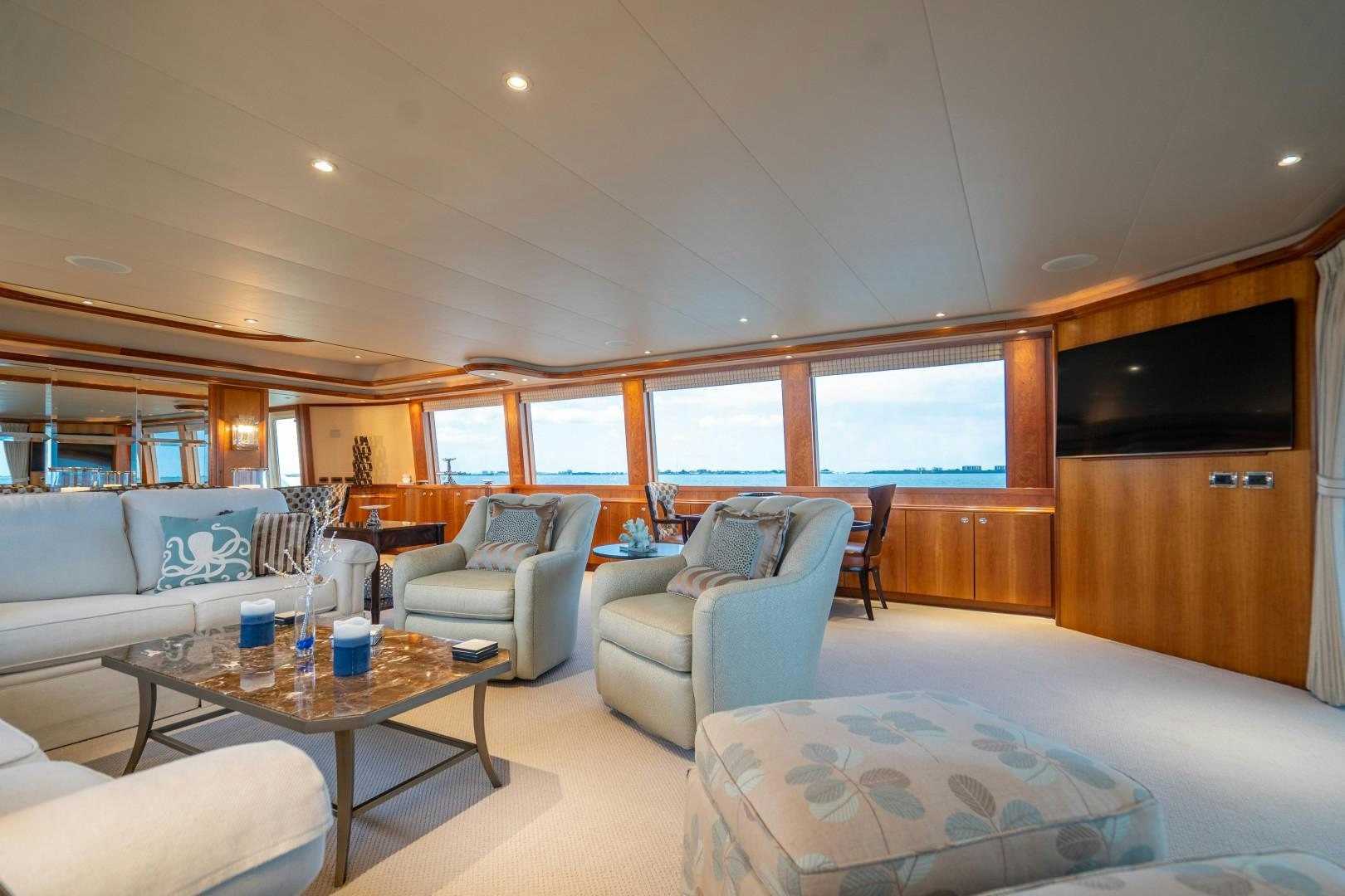 a living room with a couch and a coffee table aboard LEGACY Yacht for Sale
