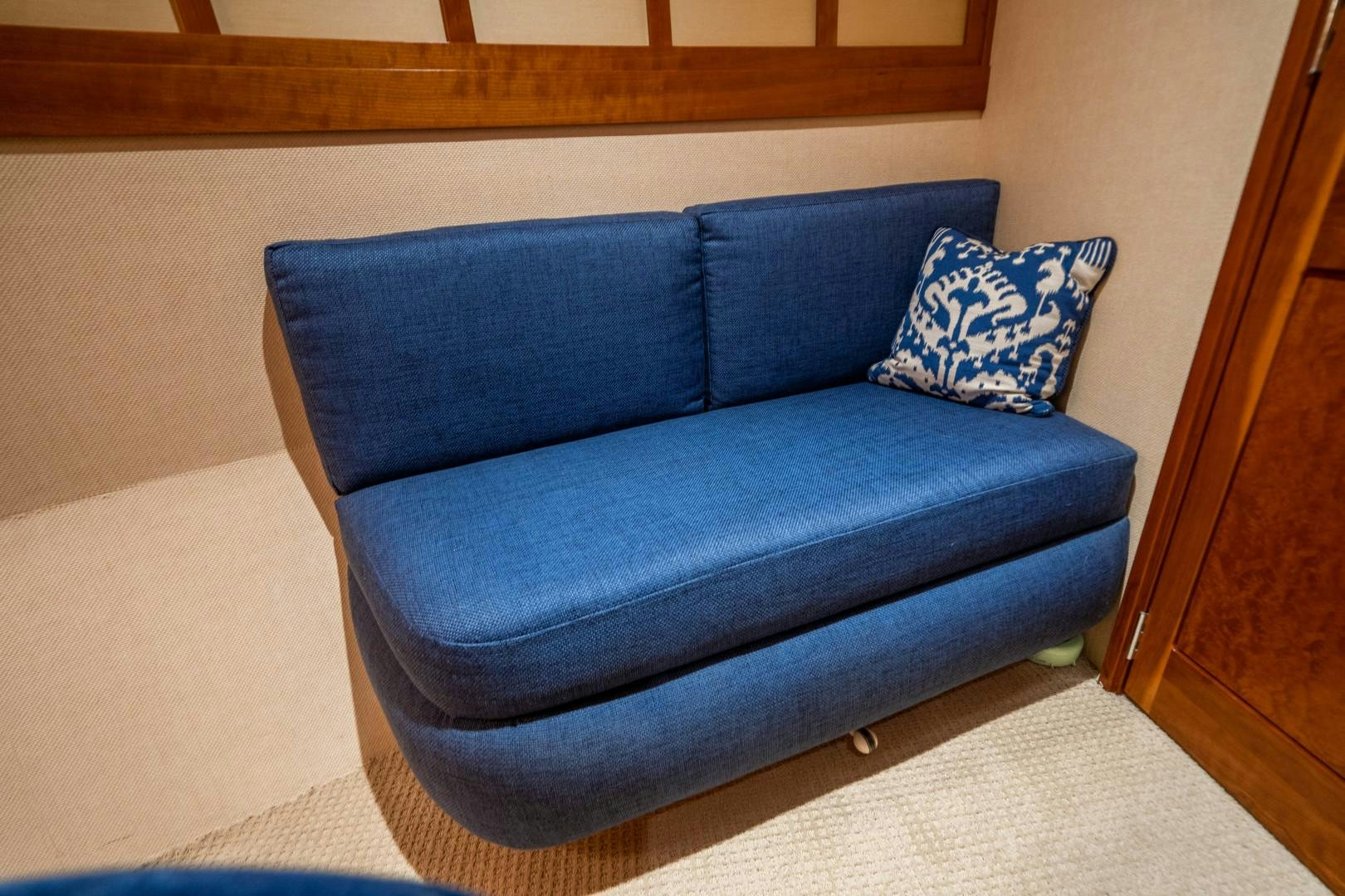 a blue couch in a room aboard LEGACY Yacht for Sale