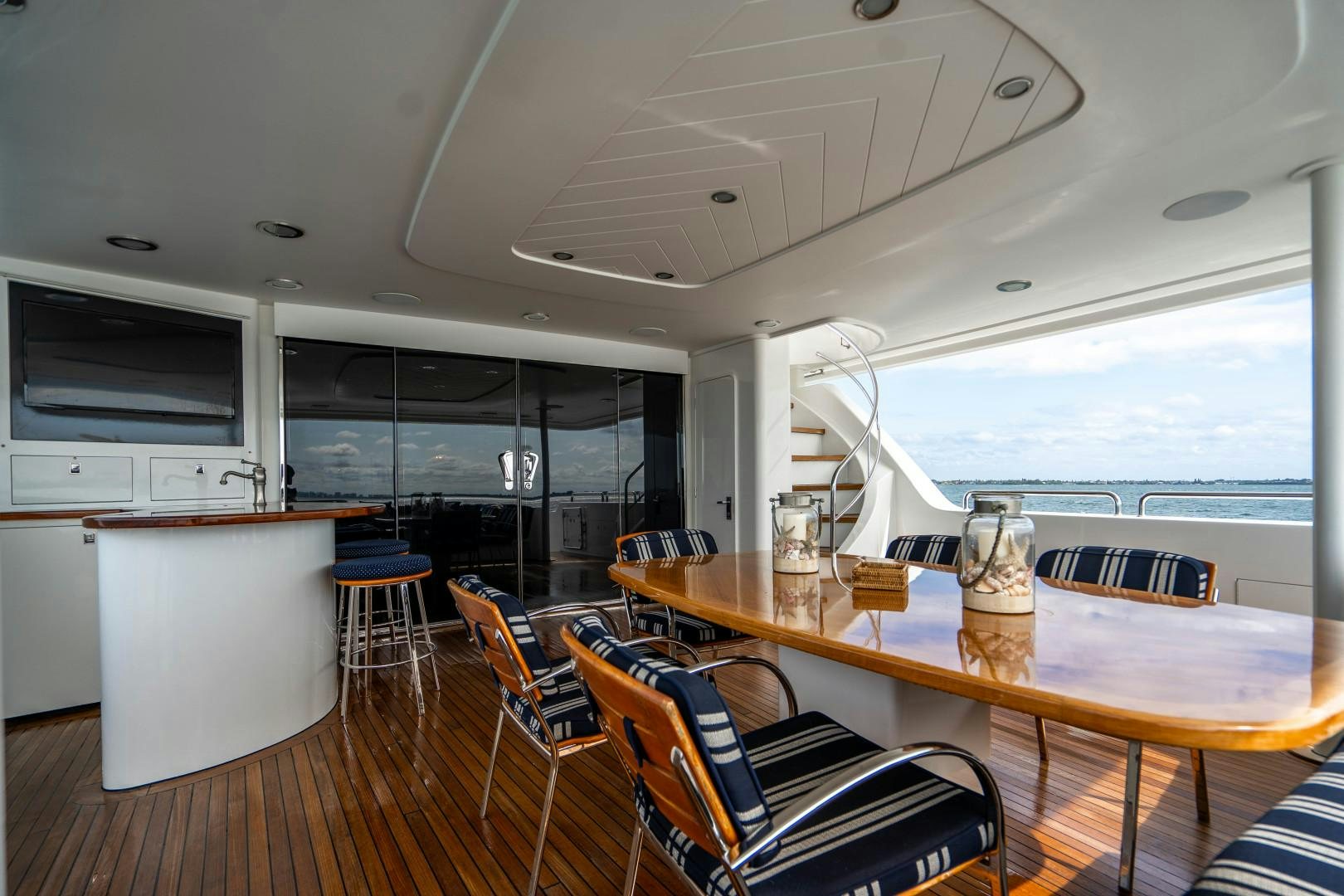 a room with a table and chairs aboard LEGACY Yacht for Sale