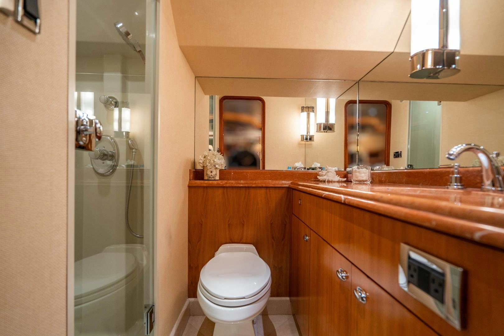 a bathroom with a toilet and a sink aboard LEGACY Yacht for Sale