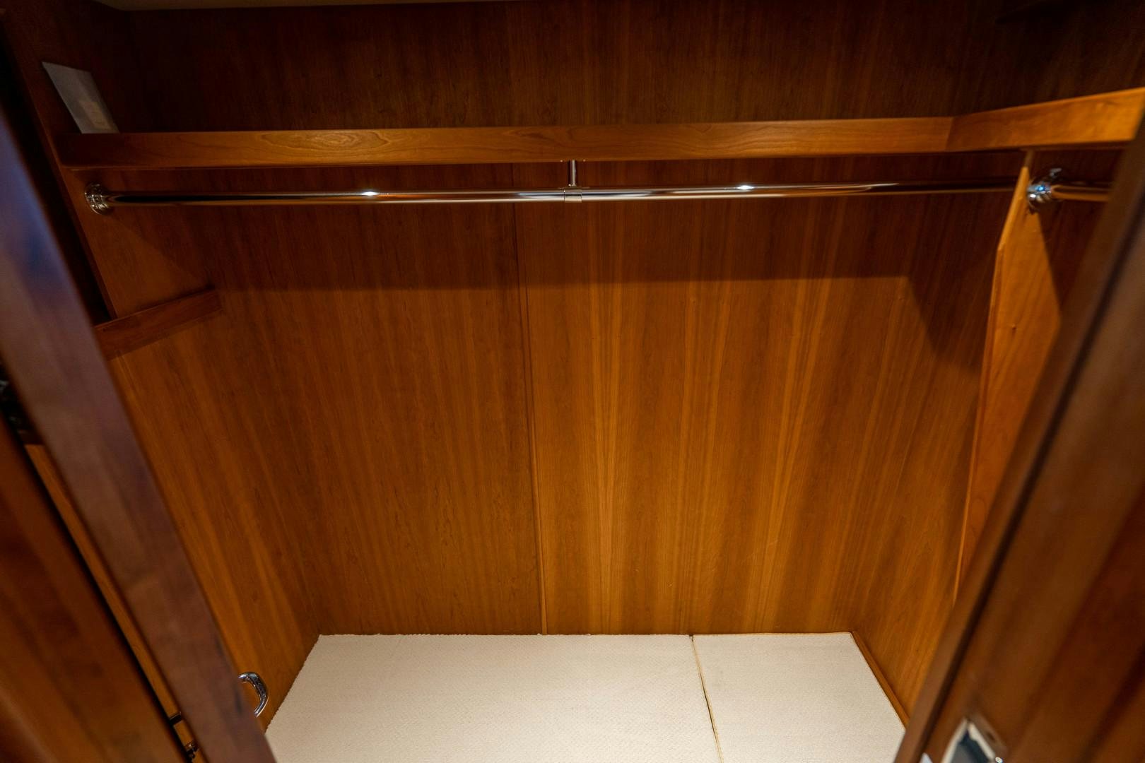a wooden cabinet with a white counter aboard LEGACY Yacht for Sale